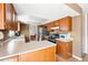 Kitchen with oak cabinets, white countertops, stainless steel refrigerator, and hardwood floors at 466 S Kingston Cir, Aurora, CO 80012