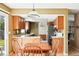 Kitchen with hardwood floors, wood table, stainless steel refrigerator, and wood cabinets at 466 S Kingston Cir, Aurora, CO 80012