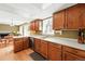 Kitchen featuring hardwood floors, oak cabinets, stainless steel sink, and white countertops at 466 S Kingston Cir, Aurora, CO 80012