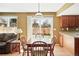 Eat-in kitchen featuring hardwood floors, breakfast table with access to backyard, wood cabinets, and natural light at 466 S Kingston Cir, Aurora, CO 80012