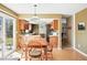 Bright kitchen with hardwood floors, wood table, stainless steel appliances, and wood cabinets at 466 S Kingston Cir, Aurora, CO 80012