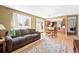 Open concept living room, dining area, and kitchen featuring a seamless and modern design at 466 S Kingston Cir, Aurora, CO 80012