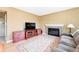 Well-lit living room featuring a fireplace, modern TV, and comfortable seating at 466 S Kingston Cir, Aurora, CO 80012