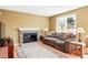 Inviting living room with a brick fireplace and lots of natural light from the window at 466 S Kingston Cir, Aurora, CO 80012