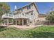 Multi-level backyard showcasing a deck, patio, spiral staircase, and well-maintained lawn at 3549 Mallard Dr, Highlands Ranch, CO 80126