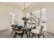 Elegant dining room with a modern glass table set, stylish decor, and view of open floor plan at 3549 Mallard Dr, Highlands Ranch, CO 80126