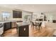 Open kitchen with granite counters and eat-in nook adjoins living room with cozy fireplace at 3549 Mallard Dr, Highlands Ranch, CO 80126