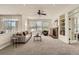 Spacious living room with cozy fireplace, built-in shelving, and abundant natural light at 3549 Mallard Dr, Highlands Ranch, CO 80126