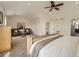 Bright main bedroom with a sitting area, neutral carpet, and a ceiling fan at 3549 Mallard Dr, Highlands Ranch, CO 80126