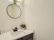 Stylish powder room features a modern round mirror and sleek fixtures at 3549 Mallard Dr, Highlands Ranch, CO 80126