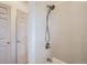Bathroom shower/tub featuring a shower head and tiled walls with the toilet and doorway nearby at 820 Kimbark St # B, Longmont, CO 80501