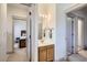 Hallway bathroom featuring a sink, mirror, and views of the bedrooms from the doorway at 820 Kimbark St # B, Longmont, CO 80501
