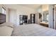 Spacious bedroom with a bed, television and an ensuite bathroom featuring a vanity at 820 Kimbark St # B, Longmont, CO 80501