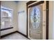 Entryway with decorative glass door, marble flooring and a transom window at 820 Kimbark St # B, Longmont, CO 80501