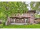 Inviting exterior of a two-story home with a charming front porch, lush trees, and vibrant green lawn at 820 Kimbark St # B, Longmont, CO 80501