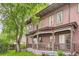 Charming exterior featuring a covered front porch, mature trees, and a well-maintained lawn at 820 Kimbark St # B, Longmont, CO 80501