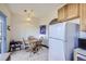 Eat-in kitchen area with a round wooden table, chairs, cabinetry and white refrigerator at 820 Kimbark St # B, Longmont, CO 80501
