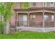 Cozy covered porch featuring seating, a lattice base, and views of the green lawn at 820 Kimbark St # B, Longmont, CO 80501