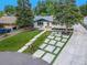 Charming single-story home featuring a landscaped front yard, modern driveway, and welcoming entrance at 1260 Hoyt St, Lakewood, CO 80215