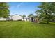 Spacious backyard features a storage shed, lush lawn, and a partially covered patio for outdoor enjoyment at 1260 Hoyt St, Lakewood, CO 80215