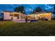 Inviting backyard featuring a cozy fire pit area and string lights for a relaxed outdoor atmosphere at 1260 Hoyt St, Lakewood, CO 80215