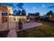 Backyard patio featuring a fire pit, outdoor seating, string lights, and well-maintained landscaping for relaxation at 1260 Hoyt St, Lakewood, CO 80215