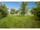 Expansive backyard with lush greenery, mature trees, and a storage shed, perfect for outdoor activities at 1260 Hoyt St, Lakewood, CO 80215