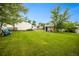 Well-maintained backyard with a large grassy area, storage shed, and mature trees providing shade at 1260 Hoyt St, Lakewood, CO 80215