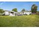 Lush backyard featuring a patio with outdoor seating, fire pit, BBQ, and manicured landscaping for outdoor living at 1260 Hoyt St, Lakewood, CO 80215