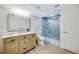 Bathroom featuring blue tiled shower and a wooden vanity at 1260 Hoyt St, Lakewood, CO 80215