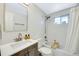 Bathroom with vanity, mirror, bathtub and tiled walls at 1260 Hoyt St, Lakewood, CO 80215