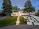 Charming single-story home featuring a landscaped front yard, modern driveway, and pathway lighting at 1260 Hoyt St, Lakewood, CO 80215