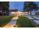 Charming single-story home featuring a landscaped front yard, modern driveway, and pathway lighting at 1260 Hoyt St, Lakewood, CO 80215