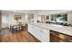 Open concept kitchen with quartz countertops, stainless steel appliances, and hardwood floors at 1260 Hoyt St, Lakewood, CO 80215