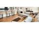 Open-concept living space featuring hardwood floors, a sectional sofa, and bar seating connecting to the kitchen at 1260 Hoyt St, Lakewood, CO 80215
