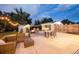 Inviting patio with comfortable seating, a fire pit, string lights, and manicured landscaping for outdoor gatherings at 1260 Hoyt St, Lakewood, CO 80215