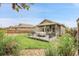 Exterior view of a home featuring a deck, covered patio, and a landscaped yard at 19210 E Pacific Pl, Aurora, CO 80013