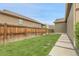 Well-maintained backyard with lush green grass and a wooden privacy fence at 19210 E Pacific Pl, Aurora, CO 80013