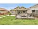 Backyard view featuring a deck, partially covered patio and green lawn at 19210 E Pacific Pl, Aurora, CO 80013