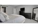 Bright bedroom featuring a queen bed, TV, and dresser, complete with a sliding barn door entry at 19210 E Pacific Pl, Aurora, CO 80013