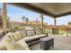 Covered patio featuring a comfortable sofa set, rug, and decorative lighting at 19210 E Pacific Pl, Aurora, CO 80013