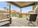 Relaxing covered outdoor deck with comfortable seating and view of the backyard at 19210 E Pacific Pl, Aurora, CO 80013
