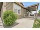 Home exterior with concrete patio, green lawn and mature landscaping at 19210 E Pacific Pl, Aurora, CO 80013