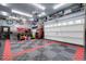 Spacious garage with a durable checkered floor and ample storage and tool areas at 19210 E Pacific Pl, Aurora, CO 80013
