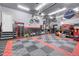 Organized garage with checkered floors, storage cabinets and a clean workspace at 19210 E Pacific Pl, Aurora, CO 80013