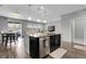 Kitchen island featuring bar stool seating, sink, stainless dishwasher, and adjacent dining area at 19210 E Pacific Pl, Aurora, CO 80013