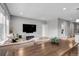 Spacious living room featuring a large sofa, mounted TV, and an open layout at 19210 E Pacific Pl, Aurora, CO 80013