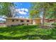 Spacious backyard features lush lawn and patio, perfect for outdoor entertaining and relaxation at 2816 S Wolff St, Denver, CO 80236