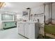 Basement laundry area with washer, dryer, work bench and plenty of room for storage at 2816 S Wolff St, Denver, CO 80236