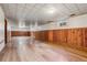 Finished basement area features wood paneling, new flooring, and ample natural light at 2816 S Wolff St, Denver, CO 80236
